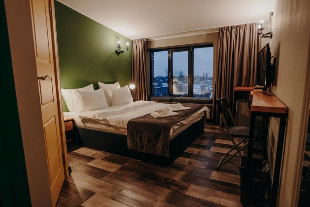 a hotel room with a bed and a window at Gutenberg Hotel in Saint Petersburg