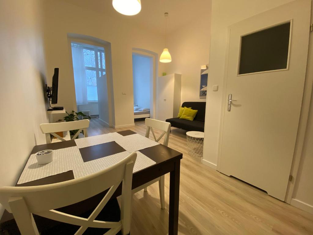 uma sala de estar com uma mesa e cadeiras num quarto em Apartamenty Sobieski em Sopot