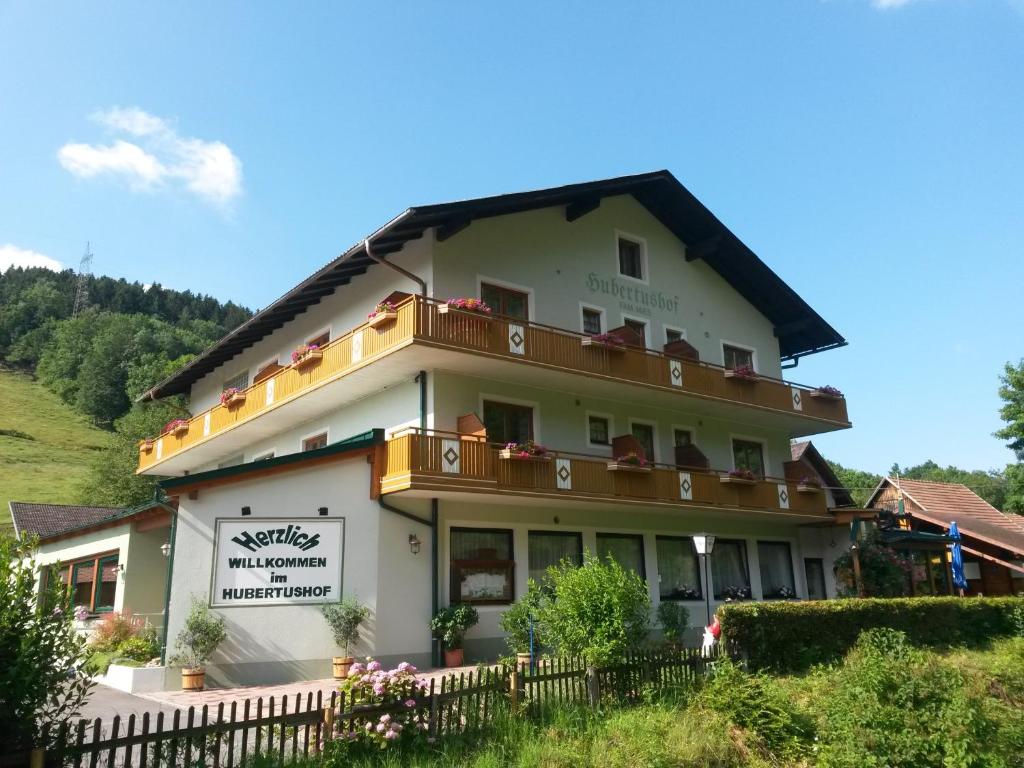 a large white building with a balcony at Hubertushof in Trattenbach