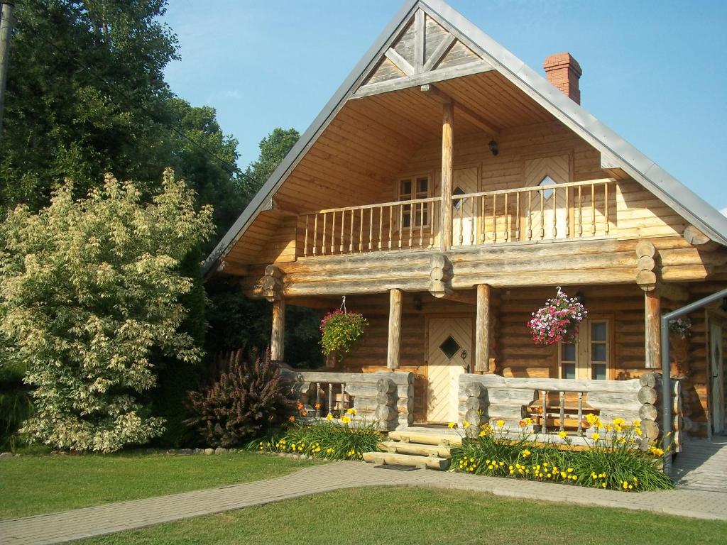 Cabaña de madera con porche y balcón en Ausekļu dzirnavu pirts, en Pastva Barbern