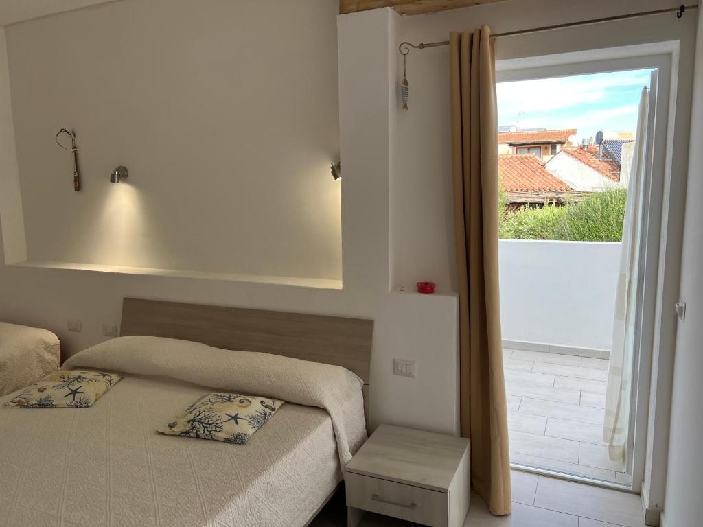 a bedroom with two beds and a large window at Al Mare da Francesca in Olbia