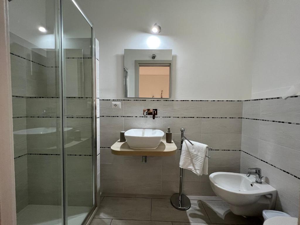 a bathroom with a sink and a glass shower at Al Mare da Francesca in Olbia