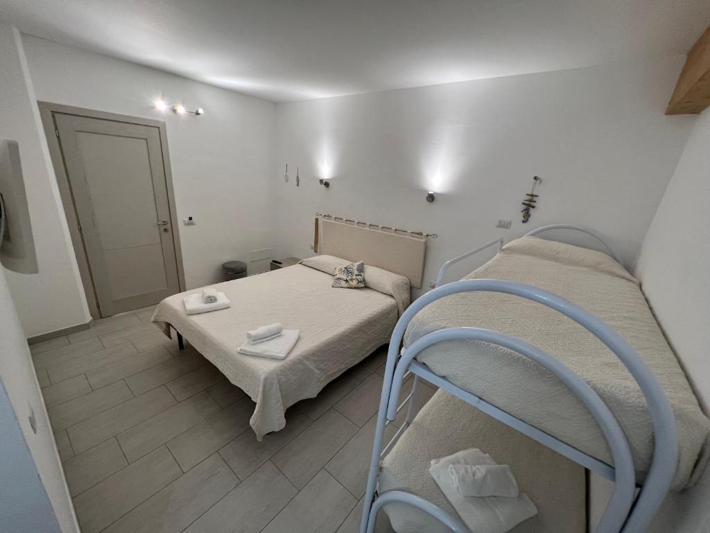 a small room with a bed and two bunk beds at Al Mare da Francesca in Olbia