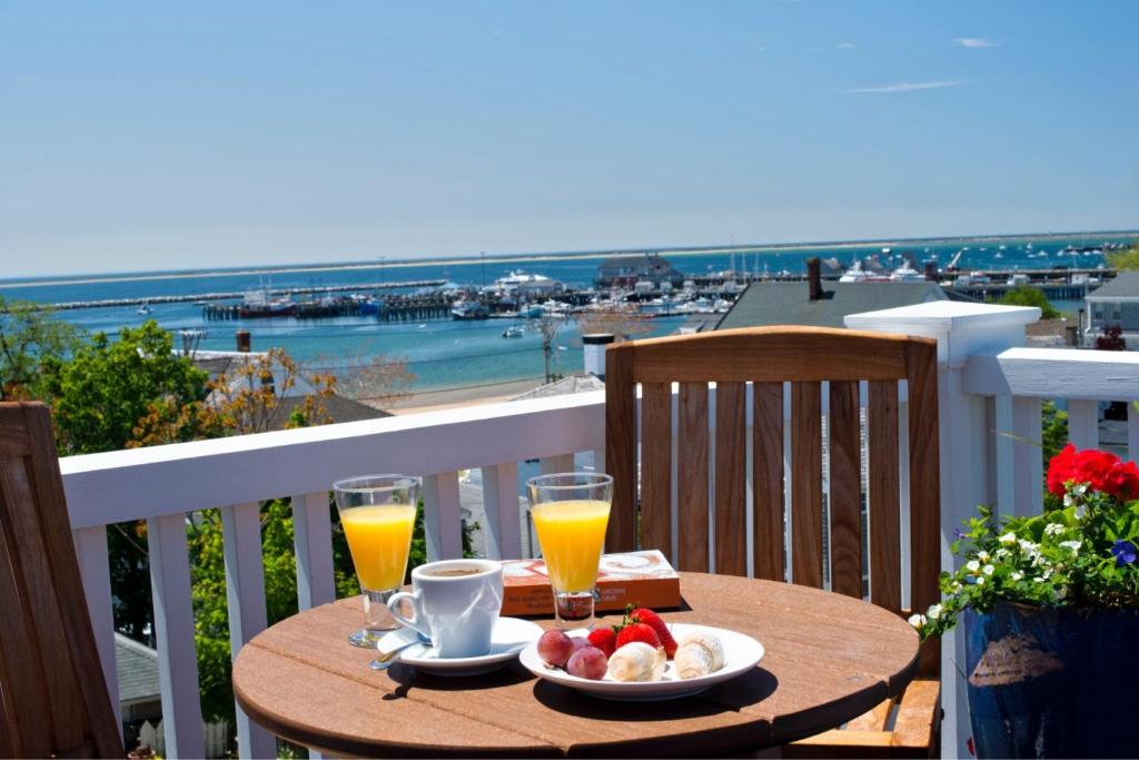 a table with food and drinks on a balcony at Benchmark Inn in Provincetown