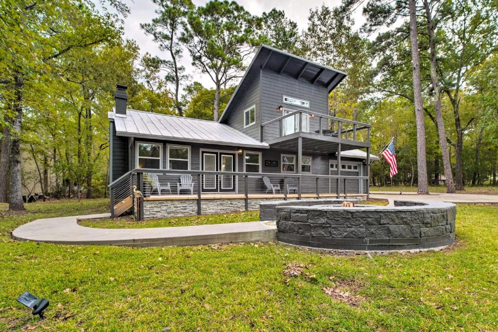 a black house with a flag in front of it at Cape Royale Cottage with Fire Pit and Water Views in Coldspring
