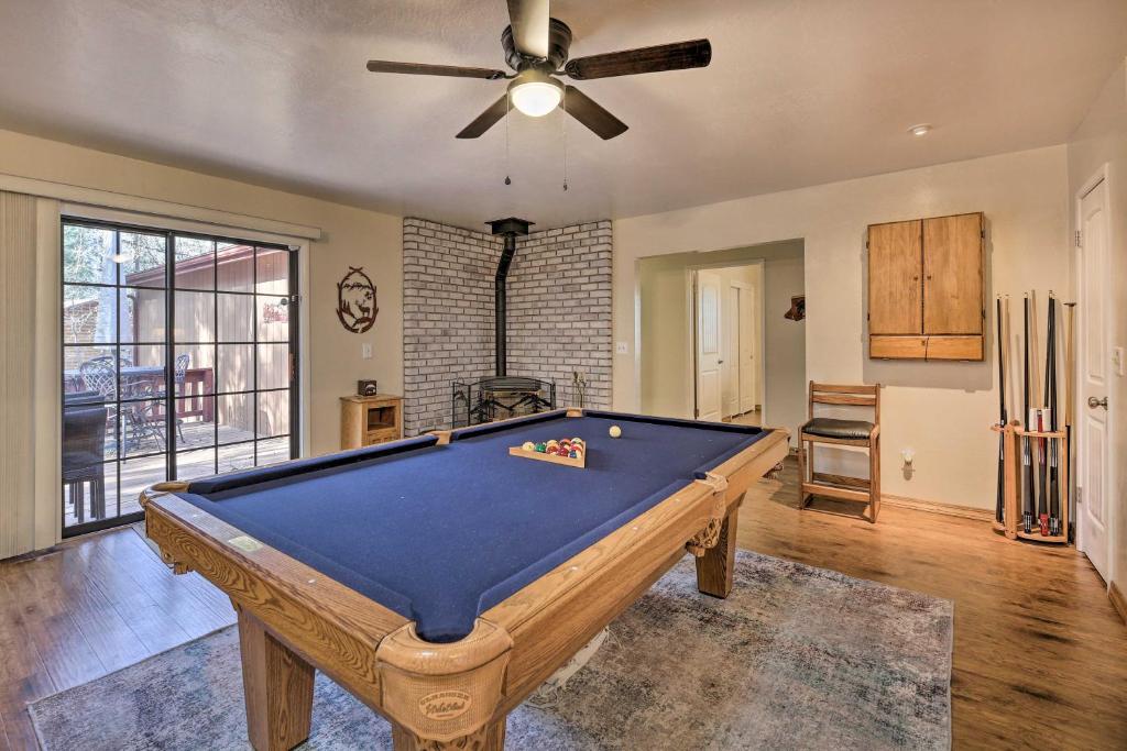 a pool table in a living room with a ceiling fan at 32 Mi to Sunrise Park White Mountain Retreat in Indian Pine