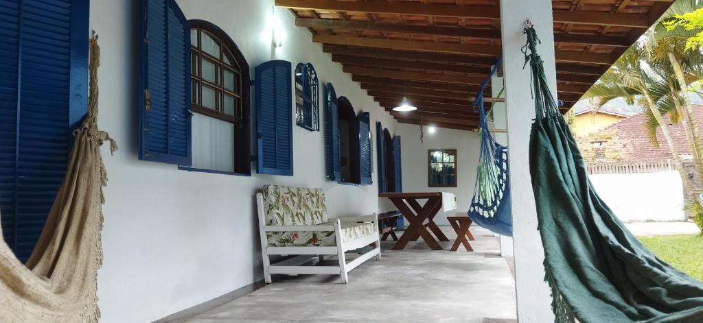 a hallway of a house with blue windows and a hammock at Juquehy Brothers House in Juquei