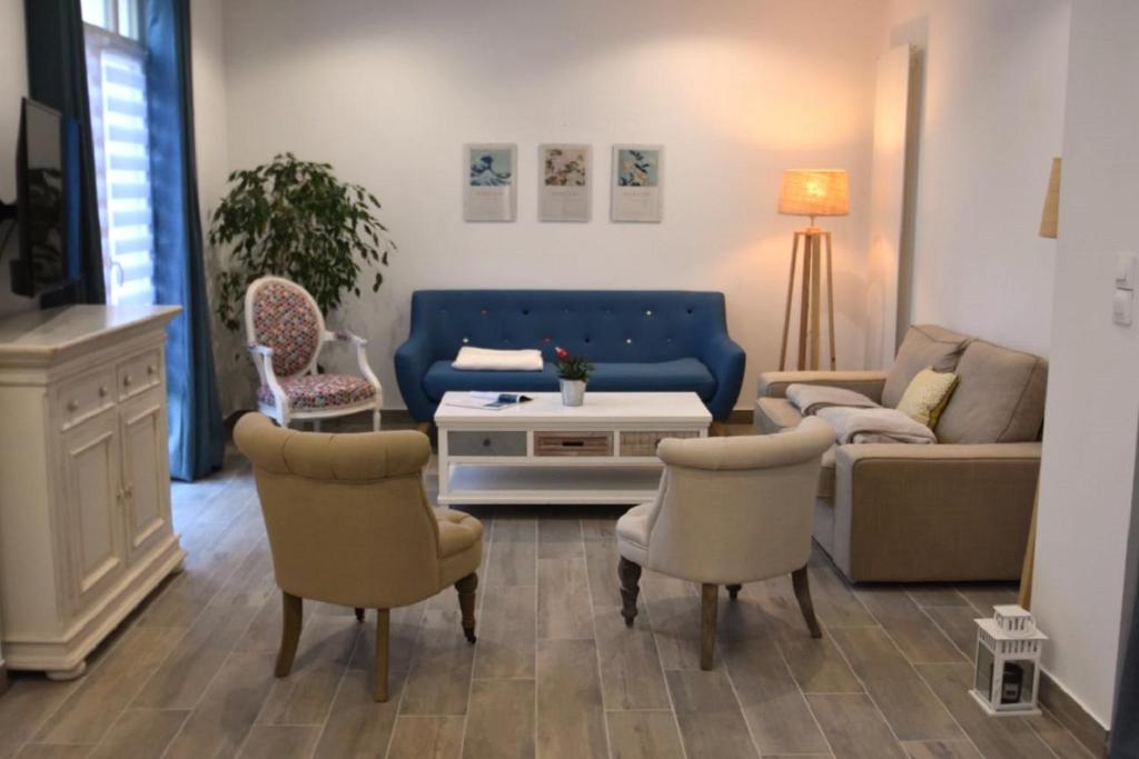 a living room with a couch and two chairs at Campagne en ville! in Compiègne