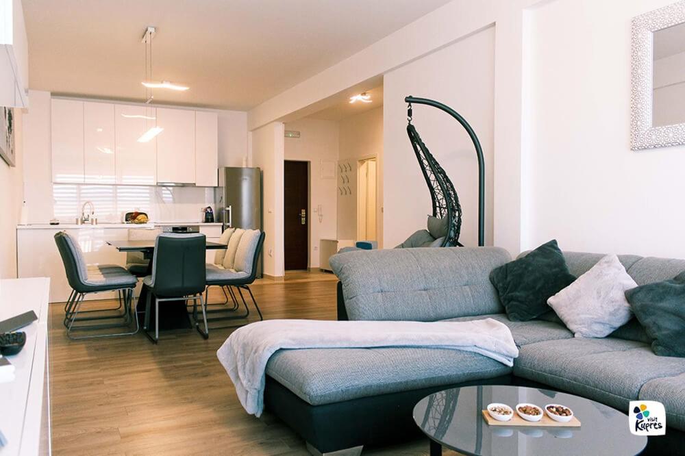 a living room with a couch and a table and a kitchen at Apartman Anđela in Kupres