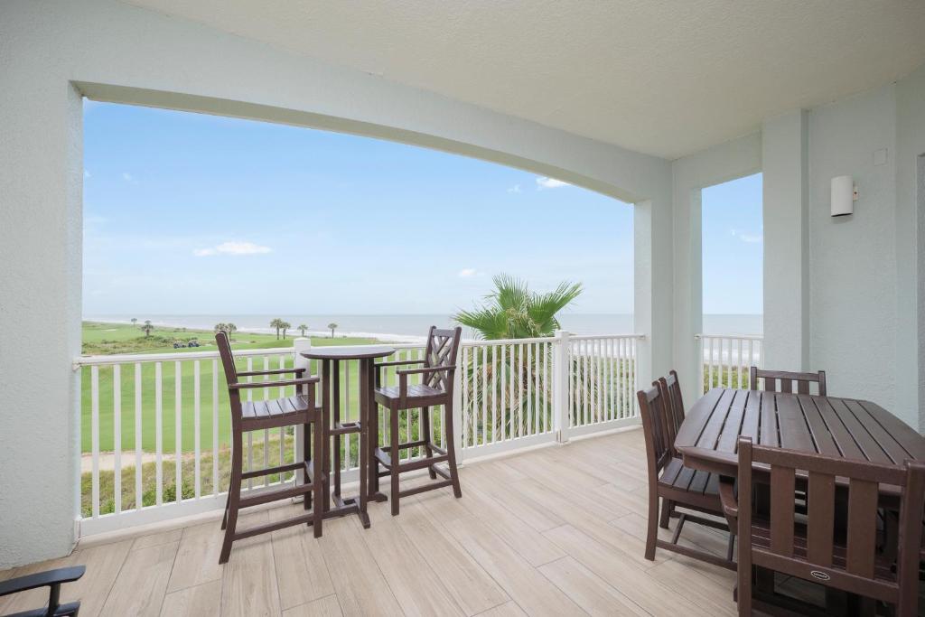 a balcony with a table and chairs and the ocean at 442 Cinnamon Beach, 3 Bedroom, Sleeps 8, Ocean View, 2 Pools, Pet Friendly in Palm Coast