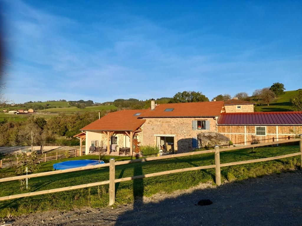 a house on a farm with a fence at Gîte Mascotte in La Gresle