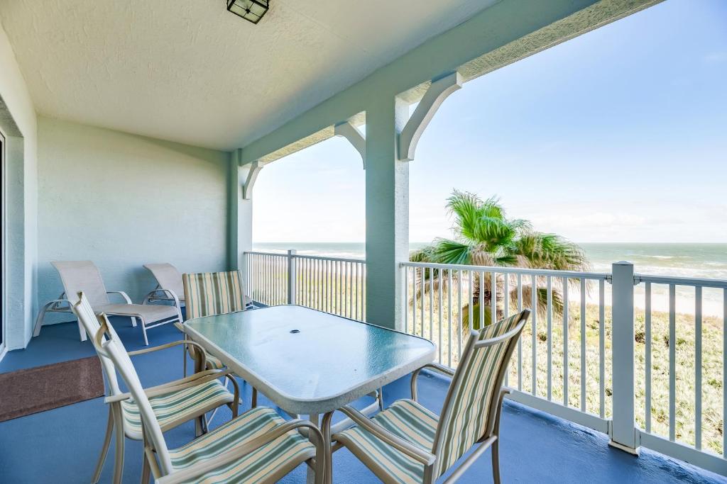 a balcony with a table and chairs and the ocean at 843 Cinnamon Beach, 3 Bedroom, Pet Friendly, Ocean Front, 2 Pools, Sleeps 8 in Palm Coast