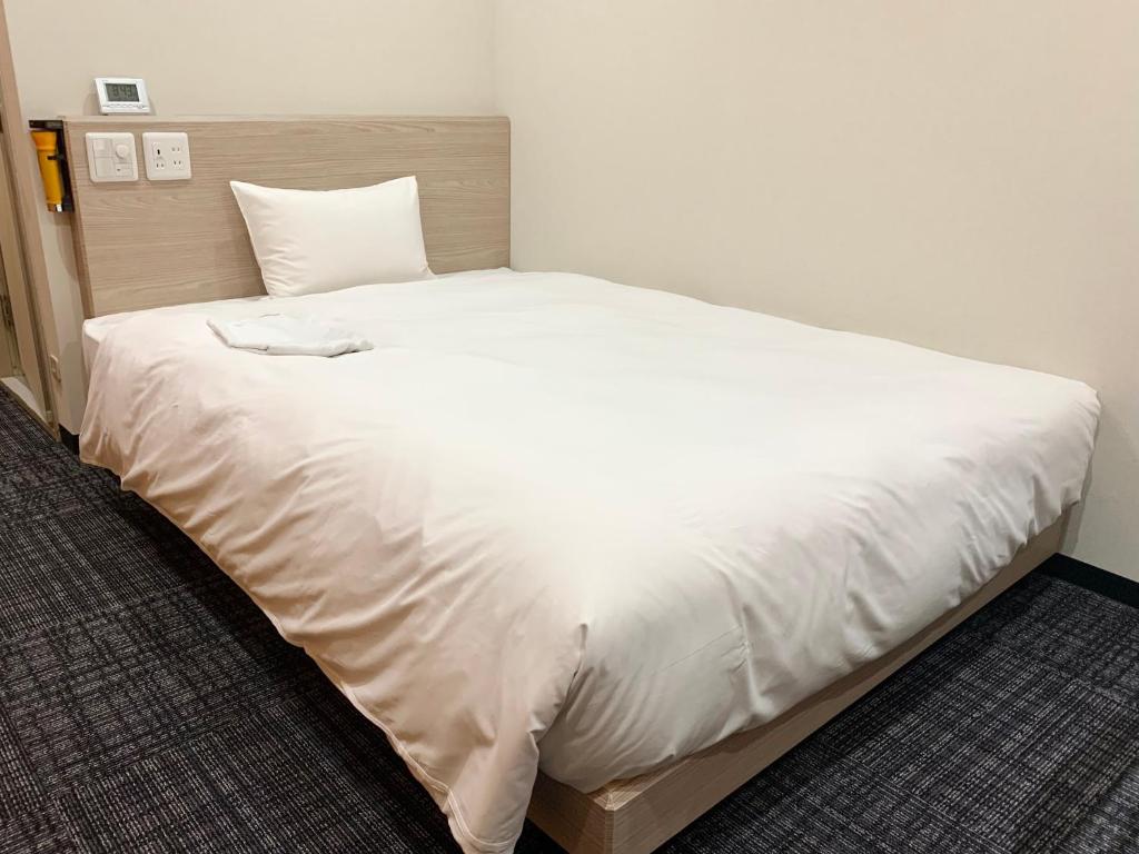 Postel nebo postele na pokoji v ubytování Hotel Ascent Hamamatsu