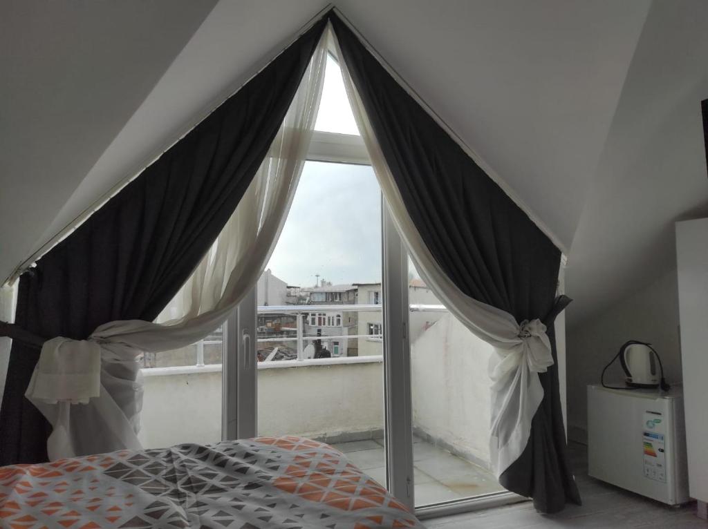 a bedroom with a bed and a window at TRIO Suite Yenikapı Old City in Istanbul