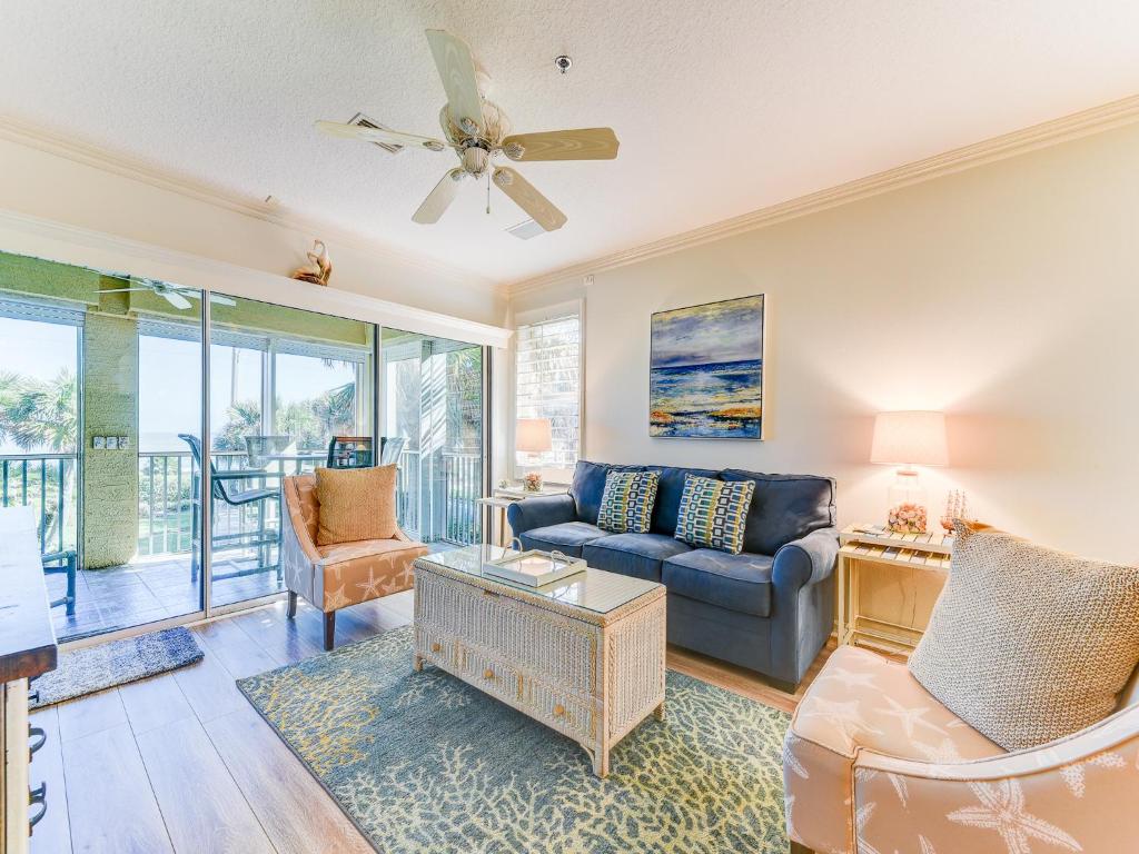 a living room with a couch and a ceiling fan at South Beach Club 205, 3 Bedrooms, Sleeps 6, Ocean View, 2nd Floor, Elevator in Flagler Beach