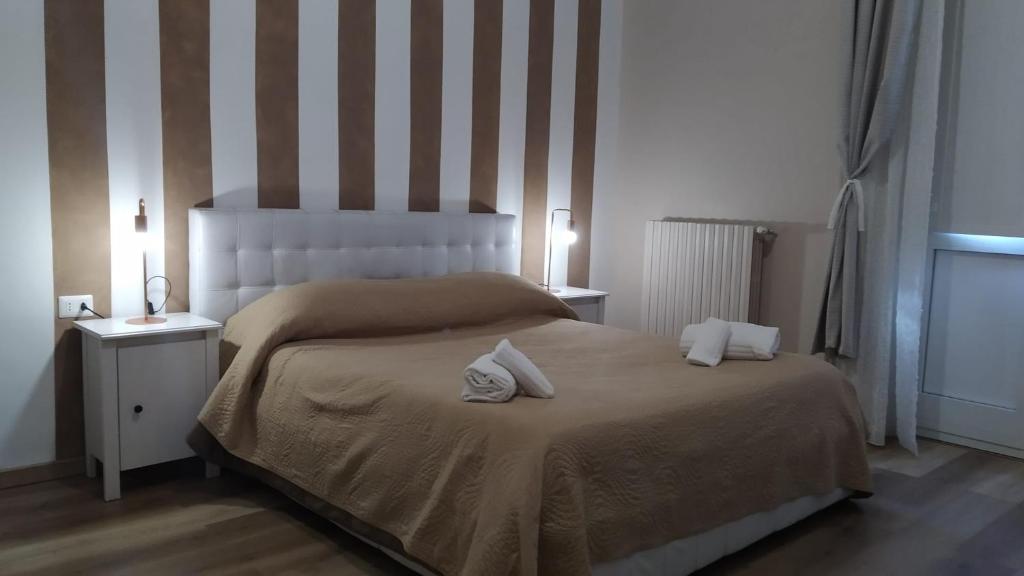 a bedroom with a bed with two towels on it at CconfortHotels R&B Dolci Notti in Bari