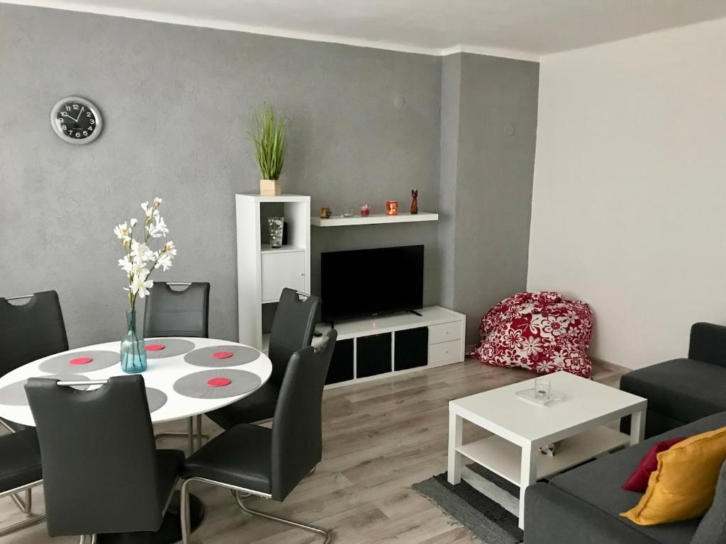 a living room with a table and a tv at Byt v blízkosti centra in Klášterec nad Ohří