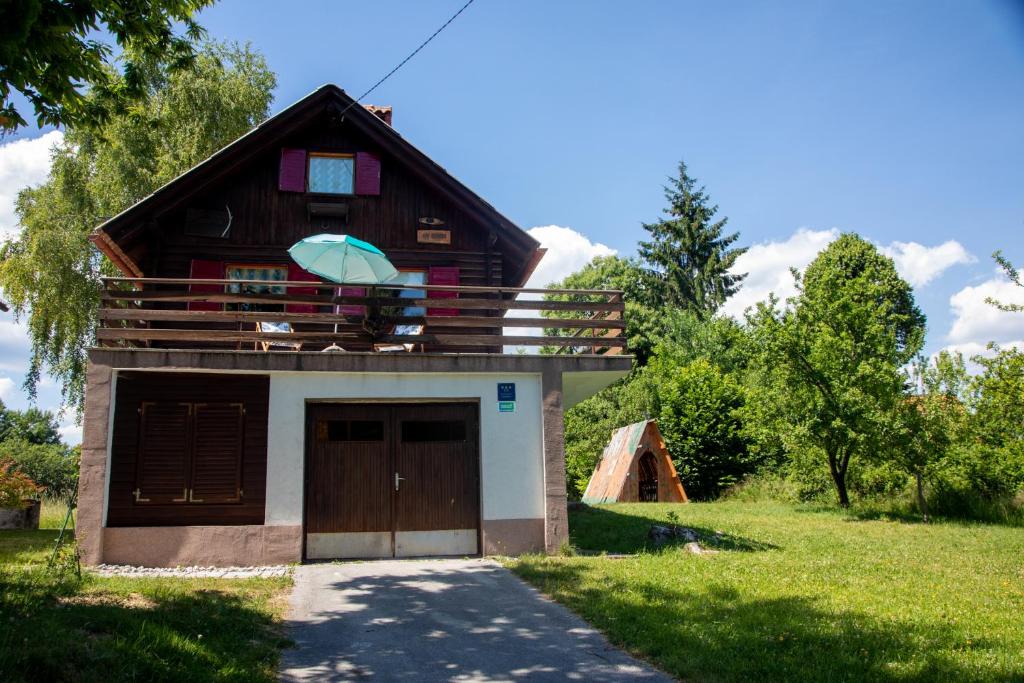 a house with a gambrel roof with a garage at My dream house in Vrhovci