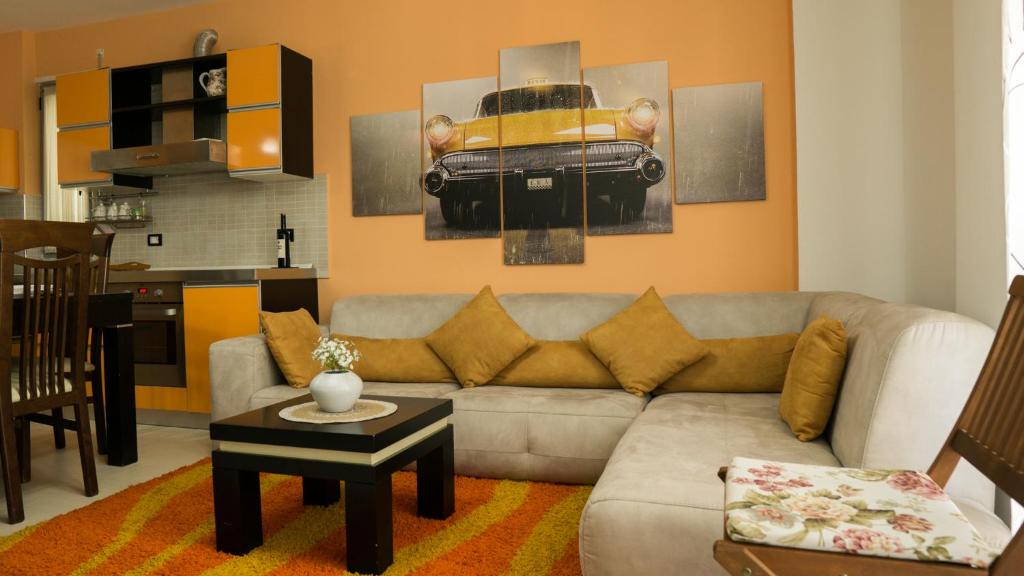 a living room with a couch and a table at Eka Luxury Two-Bedroom Penthouse in Durrës