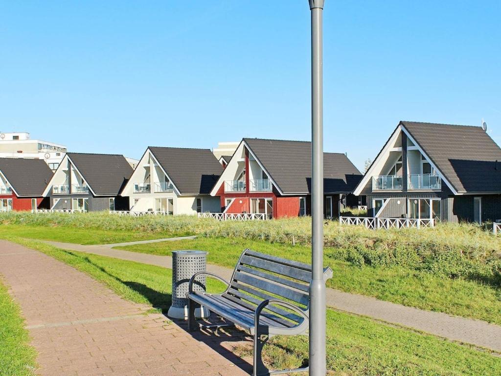 a park bench next to a street light and houses at 4 person holiday home in Wendtorf in Wendtorf