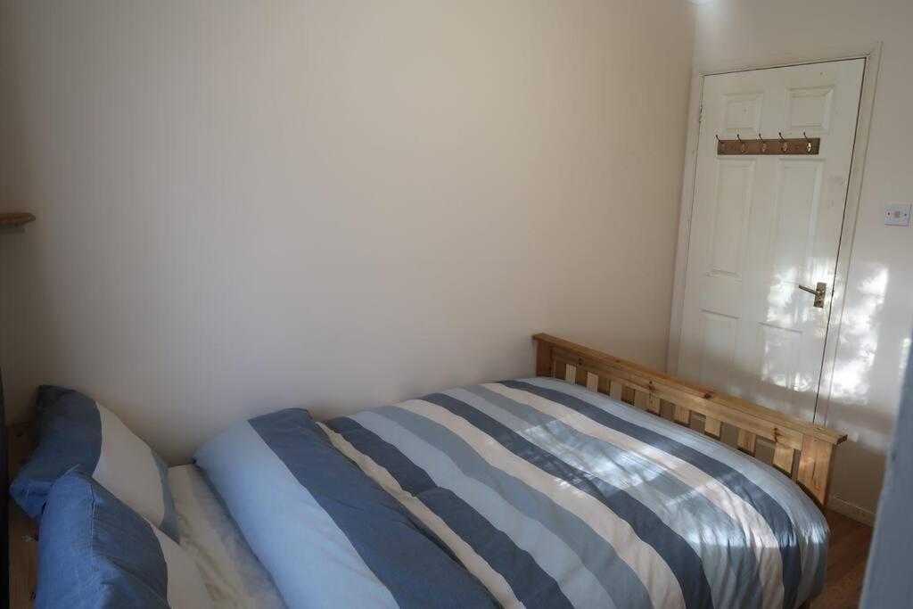 a small bedroom with a bed in a room at Spacious 4 bed Farnborough AirShow in Blackwater