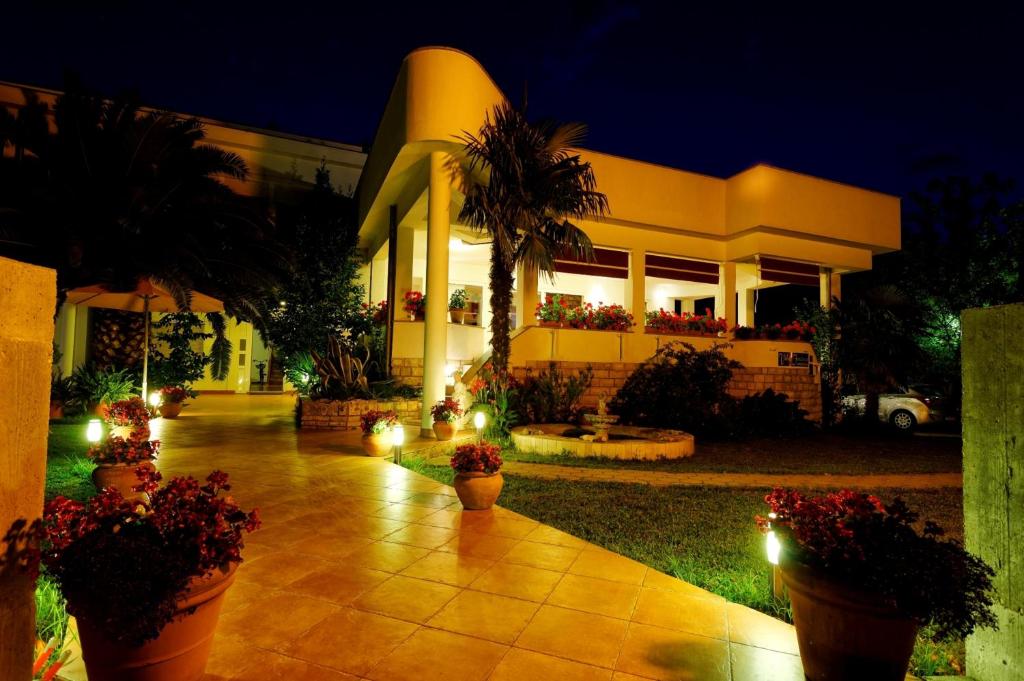 a house with lights in front of it at night at Villa Fontana in Sukošan