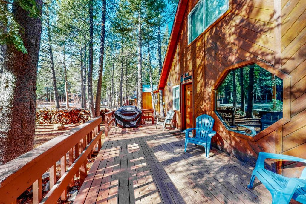 a cabin in the woods with a wooden deck at Truckee Mountain Retreat in Truckee