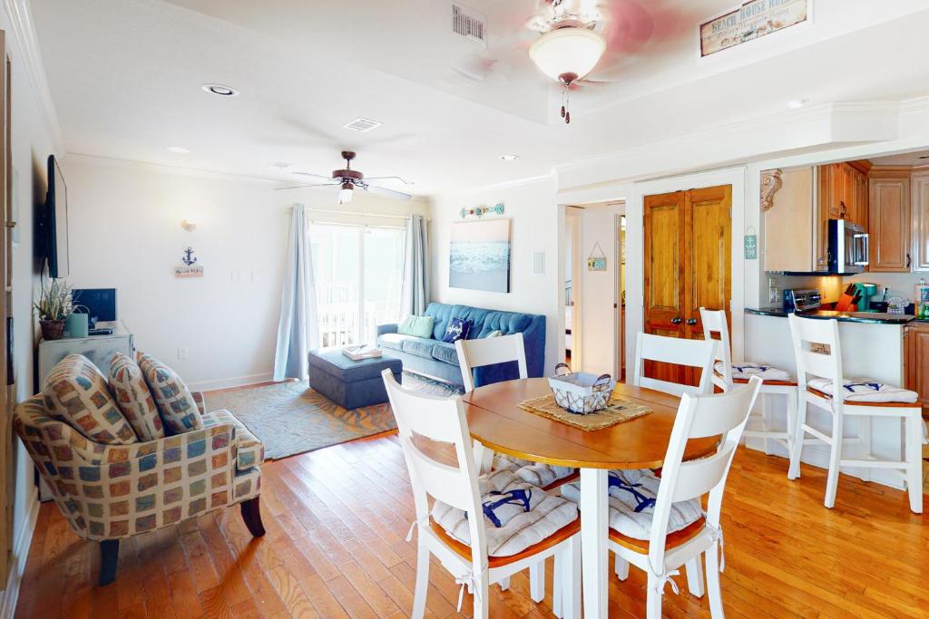 a kitchen and living room with a table and chairs at Sea Cabin 6A in Destin