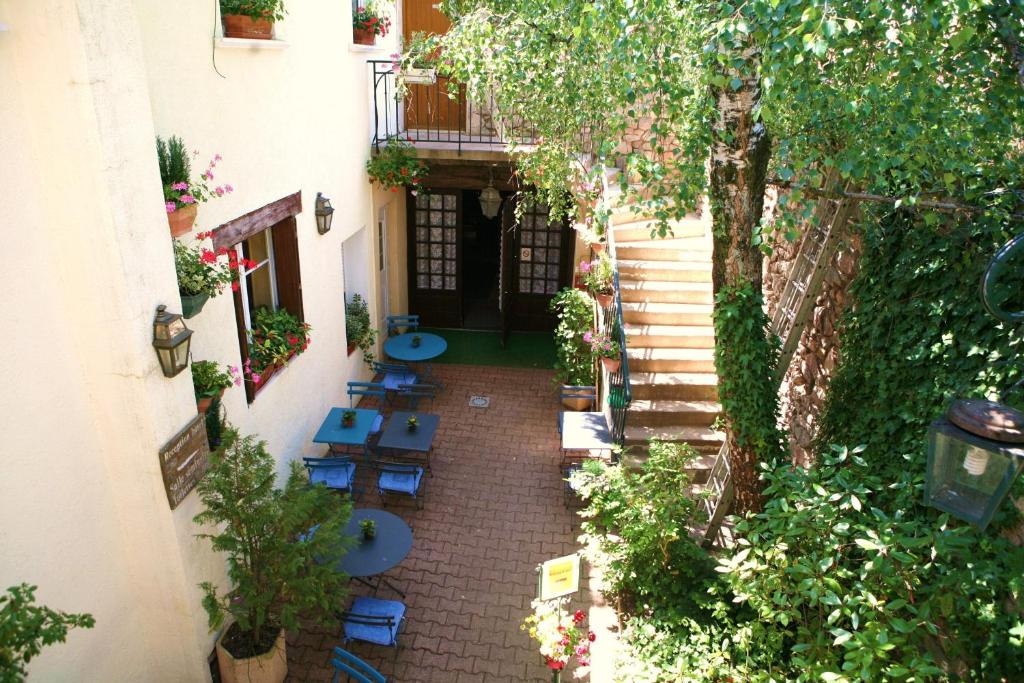 an overhead view of a courtyard with blue chairs at Hotel de Bourgogne in Saulieu