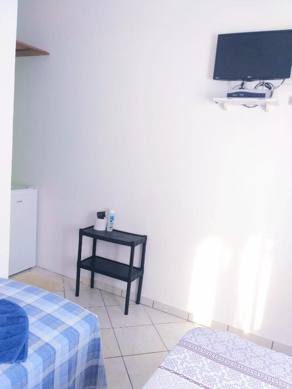 Postel nebo postele na pokoji v ubytování SUITES COR DO SOL TRINDADE