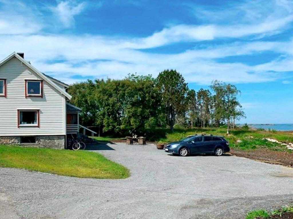 a car parked in a driveway next to a house at 9 person holiday home in Fj rtoft in Fjørtoft