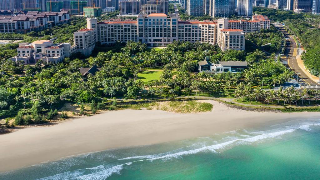 an aerial view of the beach in front of the city at Grand Hotel Haikou - Managed by Accor in Haikou