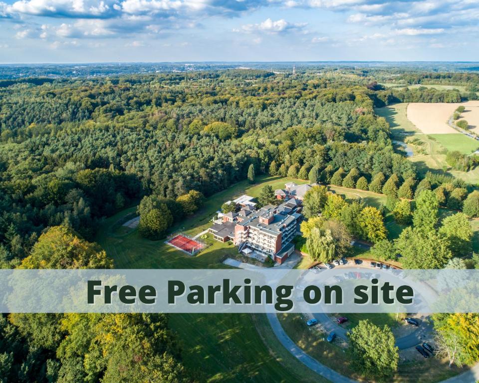 an aerial view of a mansion in a forest at ibis Styles Louvain-la-Neuve Hotel and Events in Louvain-la-Neuve
