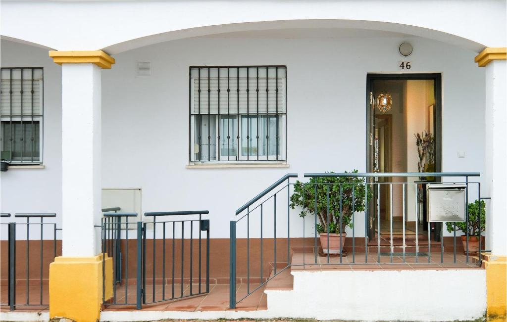 a white building with a staircase in front of a door at Stunning Home In La Algaba With 3 Bedrooms in La Algaba