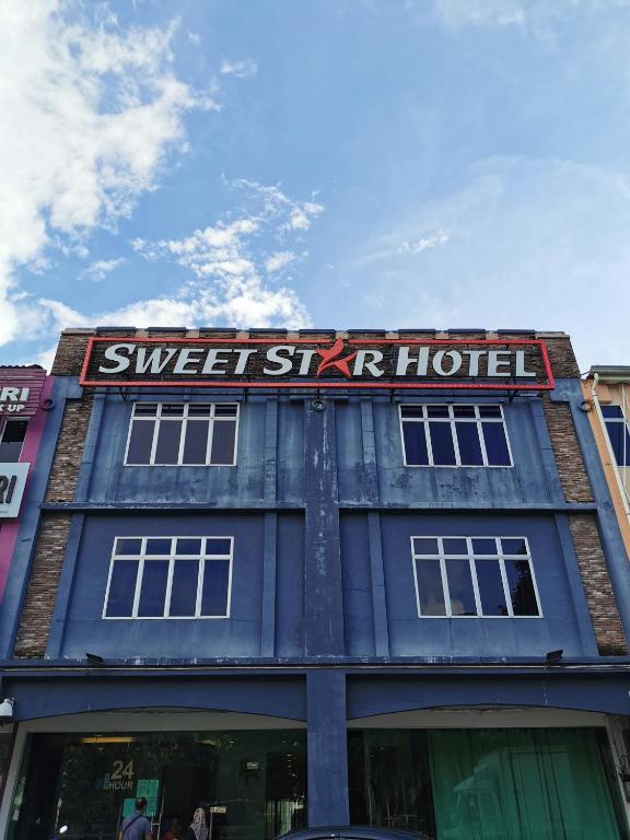 a blue building with a sign that reads sweet sky hotel at Sweet Star Hotel in Alor Setar