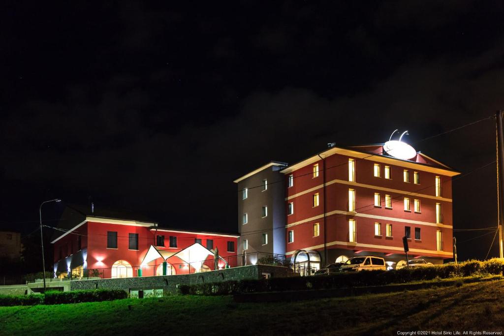 a building with lights on it at night at Sirio Life Hotel in Trissino