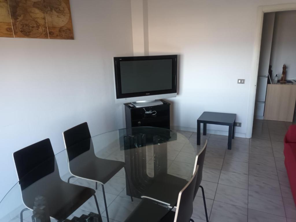salon ze szklanym stołem i telewizorem w obiekcie Appartamento Belvedere w mieście Chieti