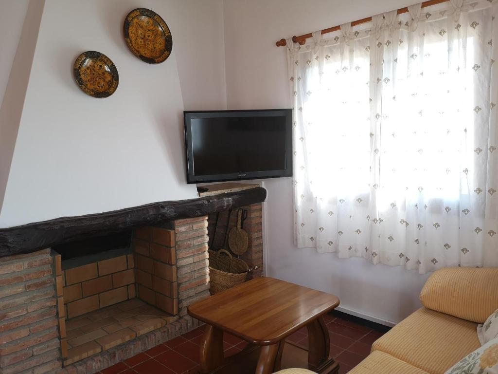 A television and/or entertainment centre at LLOGUER30 La Rajoleria para desconectar