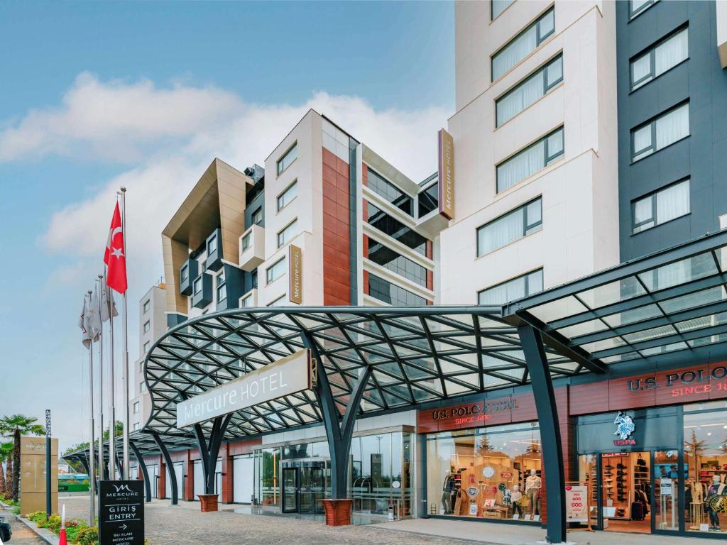 a building with a metal canopy in front of it at Mercure Trabzon Hotel in Trabzon