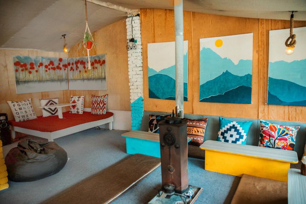 a room with a couch and some pillows in it at Young Monk Hostel & Cafe Old Manali in Manāli