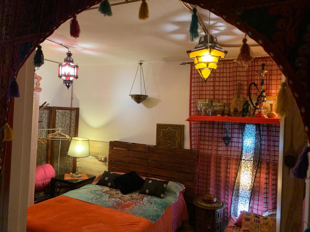 a bedroom with a bed in a room with lights at La Casa del Pianista in Monachil