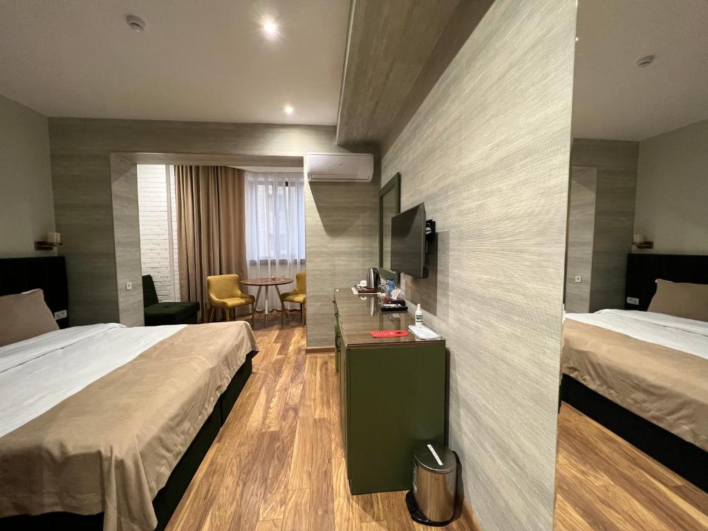 Postel nebo postele na pokoji v ubytování CH Hotel