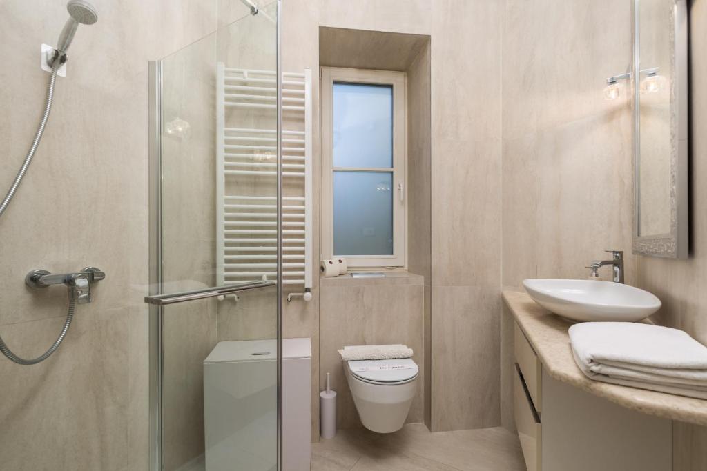 a bathroom with a shower and a toilet and a sink at Villa Sokol Apartments Opatija center in Opatija