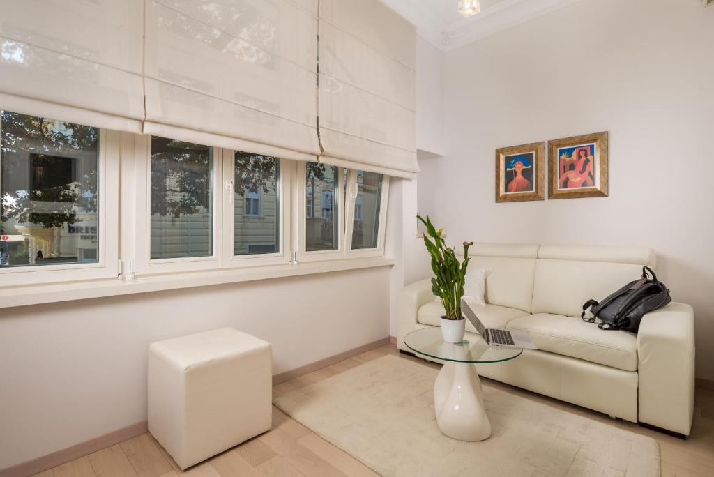a living room with a couch and a table at Villa Sokol Apartments Opatija center in Opatija