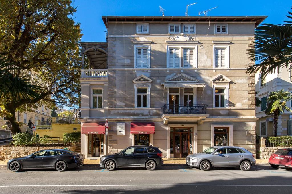 a building with cars parked in front of it at Villa Sokol Apartments Opatija center in Opatija