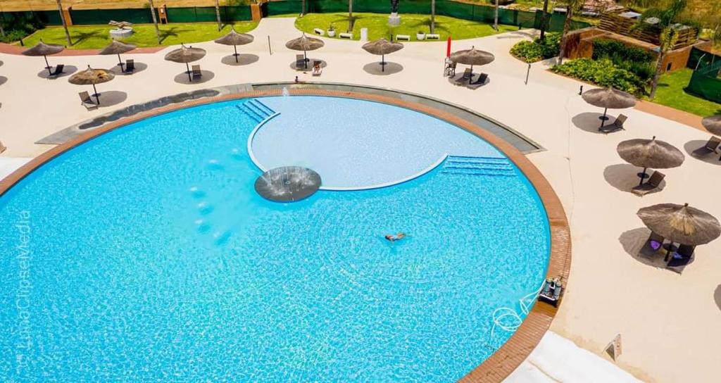 an overhead view of a large swimming pool with umbrellas at Luxury 264 The Blyde in Pretoria