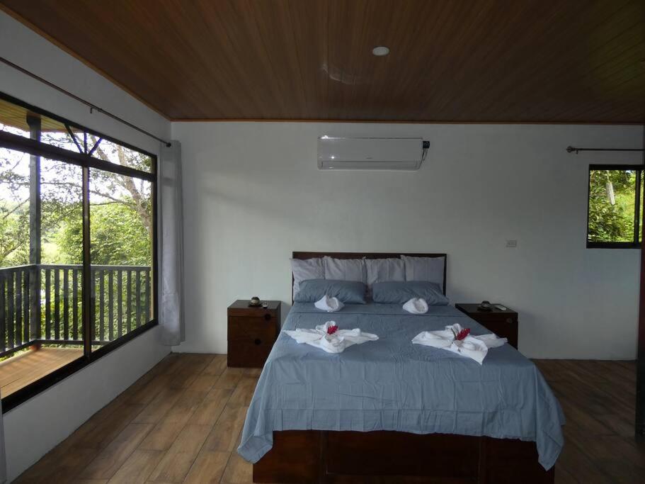 a bedroom with a bed with two towels on it at Tapiru's House - Bahia Drake in Drake
