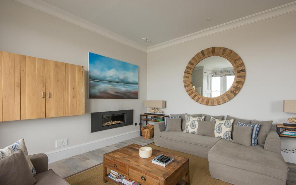 a living room with a couch and a mirror at The Beach House in North Berwick