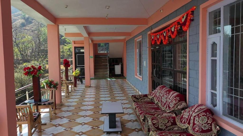 a porch of a house with a couch and a window at Riva palace Homestay Rewalsar Lake in Malther