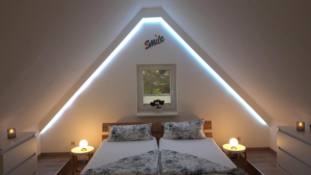 a bedroom with two beds with lights on the ceiling at Ferienwohnung an der Kurklinik in Bad Driburg